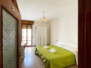 um quarto com uma cama verde num quarto em Casa Gramsci - Affitti Brevi Italia em Módena
