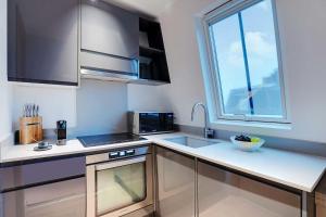 a small kitchen with a sink and a window at Chic Parisian Getaway 4P1BR - Victor Hugo in Paris