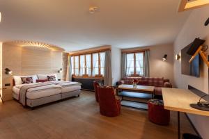 Postel nebo postele na pokoji v ubytování Sonne Andermatt Swiss Quality Hotel
