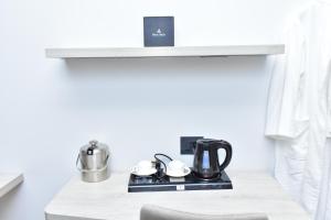 a kitchen counter with a coffee maker on a stove at Hotel Stella 