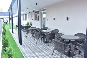 a row of tables and chairs on a patio at Hotel Stella 