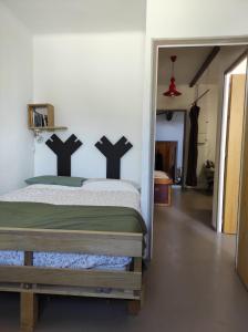 a bedroom with a bed with black crosses on the wall at Y here in Vaison-la-Romaine