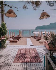 a beach with umbrellas and chairs and the ocean at Mr Crane Hotel in Kemer