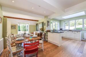 a kitchen and dining room with a table and chairs at Sea Way in Middleton-on-Sea