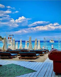 a row of chairs and umbrellas on a beach at Mr Crane Hotel in Kemer