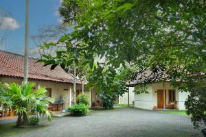 a building with a courtyard in front of it at Front One Resort Indraloka Temanggung in Temanggung