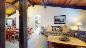 a living room with a couch and a table at Mammoth Estates Condo - Near Village at Mammoth & Pet Friendly in Mammoth Lakes