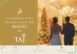 a man and a woman standing in front of a christmas tree at Vivanta Colombo, Airport Garden in Negombo