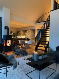 a living room with a staircase and a fireplace at N6Quartier in Bad Münstereifel
