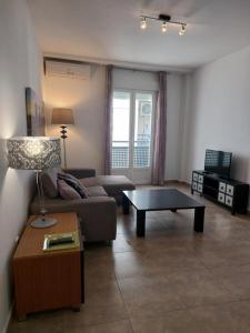 a living room with a couch and a coffee table at Apartamento JALAMA 2B in Moraleja
