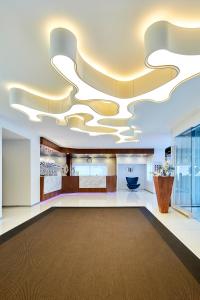 a large lobby with a large ceiling at Santa Eulalia Hotel & Spa in Albufeira
