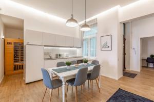 a kitchen and dining room with a table and chairs at Exclusive Central Home with Sauna next to the New York Café in Budapest