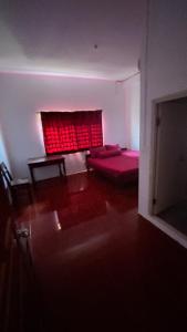 a living room with a red window and a couch at Siem Reap Holiday Guest House or Motel in Siem Reap