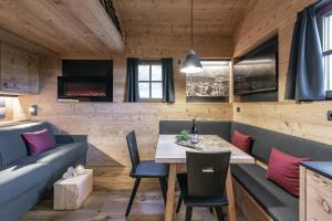 a kitchen and dining room with a table and chairs at Almhütte Tauber Fane Alm in Valles