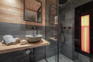 a bathroom with a sink and a shower at Almhütte Tauber Fane Alm in Valles