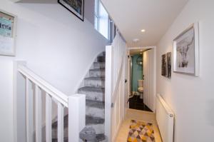 a staircase in a home with white walls at Juniper HAYLOFT, Grasmere in Ambleside
