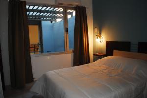 a bedroom with a bed and a large window at Pura Vida Concordia in Concordia