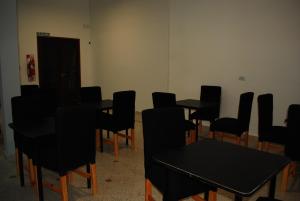 a room with black tables and black chairs at Pura Vida Concordia in Concordia