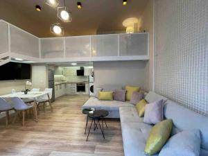 a living room with a couch and a dining room at Lovely apartment in Pogradec city with a lake view in Pogradec