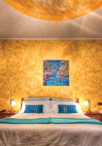 a bedroom with a large bed with blue pillows at B&B Arcobaleno in Potenza