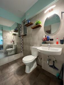 a bathroom with a toilet and a sink and a mirror at Studio Apt with Rooftop Panoramic views @ Dabolim in Vasco Da Gama