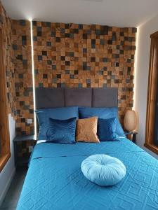 a blue bed with a pillow on top of it at Miejsce dla chcących odpocząć in Prabuty