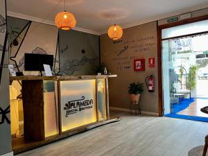 a shop with a counter and a sign on the wall at Alameda Hostal Boutique in Tarifa