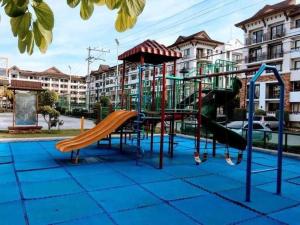 a playground with a slide on a blue ground at 1bedroom one oasis condo fullyfurnished in Davao City