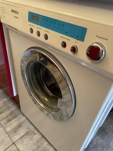 a washing machine is sitting in a room at Superbe appartement terrasse wifi in Paroy-sur-Tholon