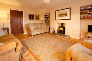 a living room with a couch and a fireplace at Beck Steps, Elterwater in Chapel Stile
