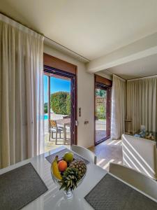a room with a table with a bowl of fruit on it at SAZ VILLAS in Syvota