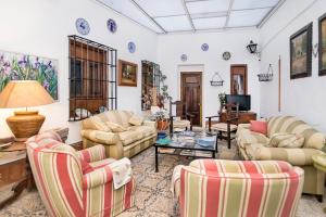a living room with couches and a table at Judería Suites in Córdoba