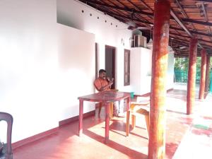 a young boy sitting at a table in a room at Ethus'villahomestay in Mararikulam