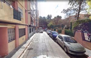 a street with cars parked on the side of the road at Golden Ambient Apartment in Chirivella