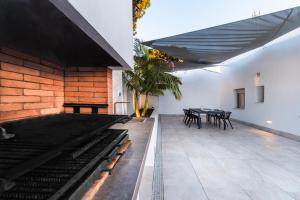 a patio with tables and chairs in a building at SIAT VIVIENDAS Villa carretera LA BARROSA in Chiclana de la Frontera