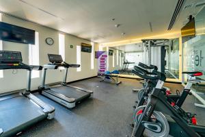 a gym with two treadmills and a treadmill at Ramada Encore by Wyndham Guadalajara Aeropuerto in Guadalajara