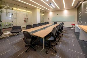 a conference room with a long table and chairs at Ramada Encore by Wyndham Guadalajara Aeropuerto in Guadalajara