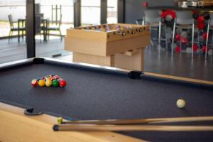 a pool table with balls on top of it at Ramada Encore by Wyndham Guadalajara Aeropuerto in Guadalajara