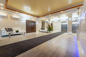 an office lobby with a waiting area with a couch and a table at Quality Inn Sunshine Suites in Terrace