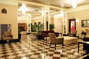 a lobby with a checkered floor and furniture in a building at Ambassador Hotel Milwaukee, Trademark Collection by Wyndham in Milwaukee