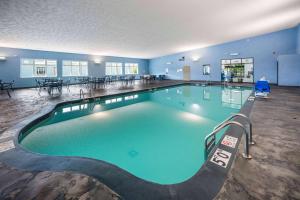 a large swimming pool in a hotel room at AmericInn by Wyndham Green Bay Near Stadium in Green Bay