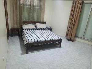 a bed sitting in a room with at Casablanca in Aïn Harrouda