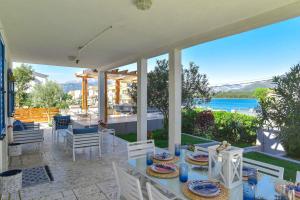 a dining table on a patio with a view of the water at Villa Gioia in Tivat