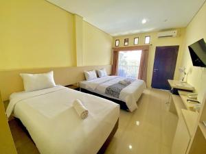 Posteľ alebo postele v izbe v ubytovaní Albero Hotel Bogor
