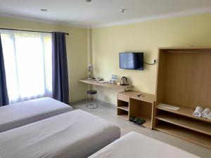 Posteľ alebo postele v izbe v ubytovaní Albero Hotel Bogor