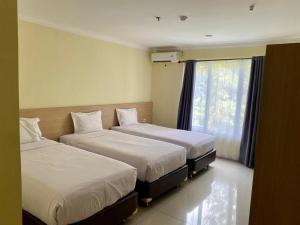 Posteľ alebo postele v izbe v ubytovaní Albero Hotel Bogor