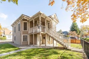 a large house with a staircase in the front yard at A+ 2 BR Victorian Home away from Home in Sacramento