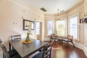 a dining room with a table and chairs at A+ 2 BR Victorian Home away from Home in Sacramento