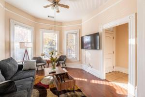 a living room with a couch and a table at A+ 2 BR Victorian Home away from Home in Sacramento
