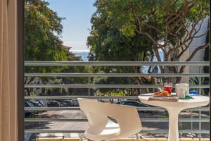 a table and chairs on a balcony with a view of the ocean at Lido View Place by An Island Apart in Funchal